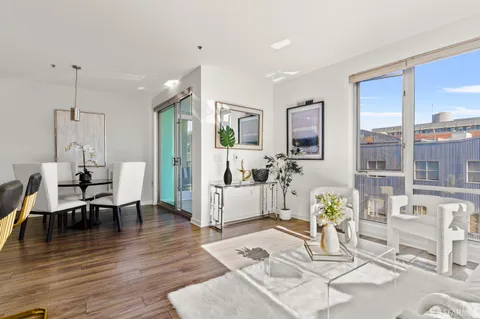 a living room with furniture dining table and wooden floor