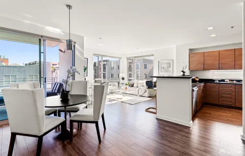 a dining room with furniture and wooden floor