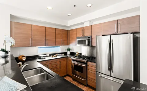 a kitchen with a refrigerator stove and cabinets