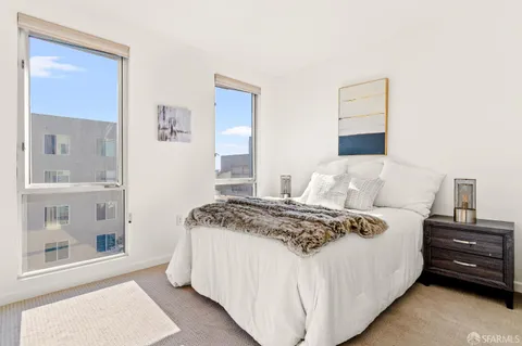 a bedroom with a bed and a large mirror