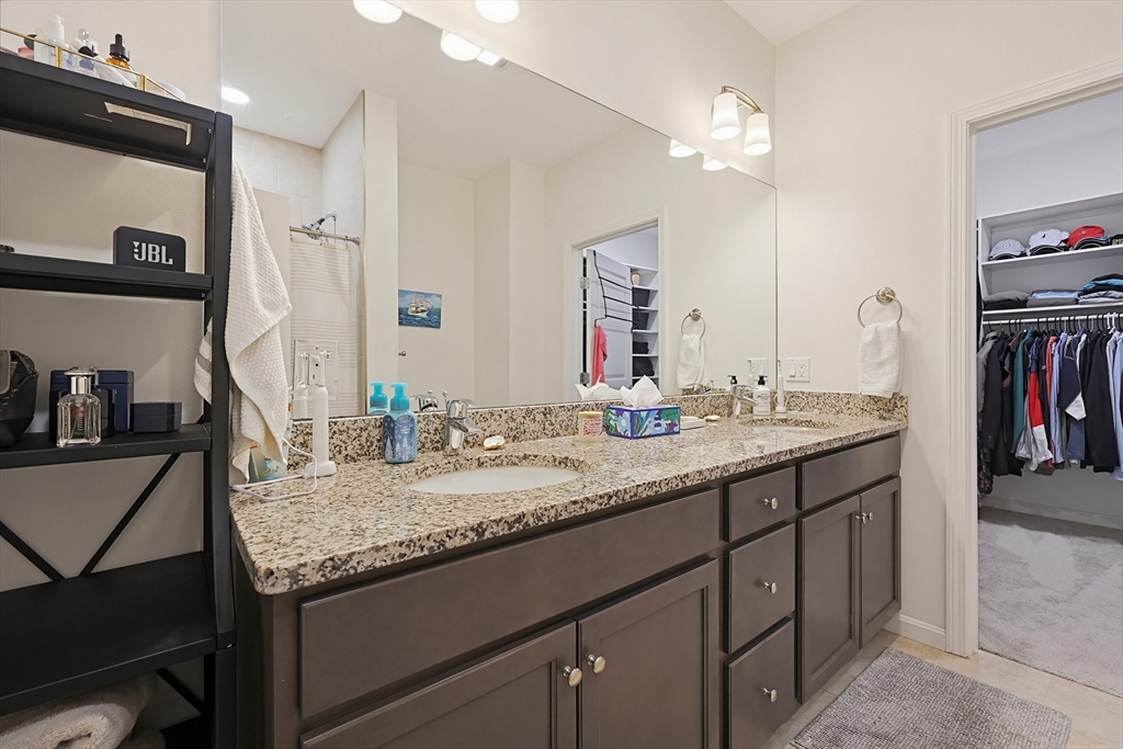 200 Revere Street, Unit 4209 Canton, MA 02021 - Photo 21 of 35 a bathroom with a granite countertop sink and a mirror