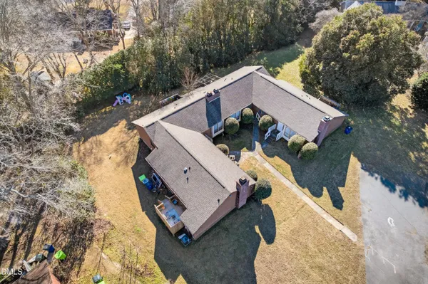 an aerial view of a house with a yard