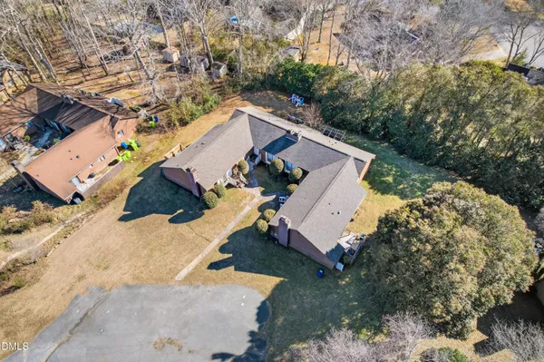 an aerial view of a house with a yard