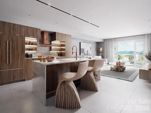 a living room with stainless steel appliances furniture a rug and a kitchen view