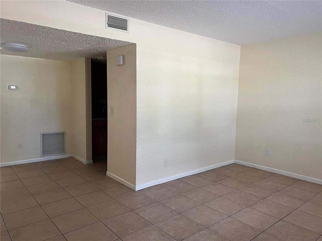 2176 Winchester Road North, Unit 2 St. Petersburg, FL 33710 - Photo 3 of 9 an empty room with windows