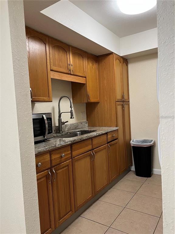 2176 Winchester Road North, Unit 2 St. Petersburg, FL 33710 - Photo 5 of 9 a kitchen with a sink and a stove
