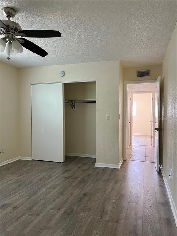 2176 Winchester Road North, Unit 2 St. Petersburg, FL 33710 - Photo 7 of 9 a view of an empty room with wooden floor