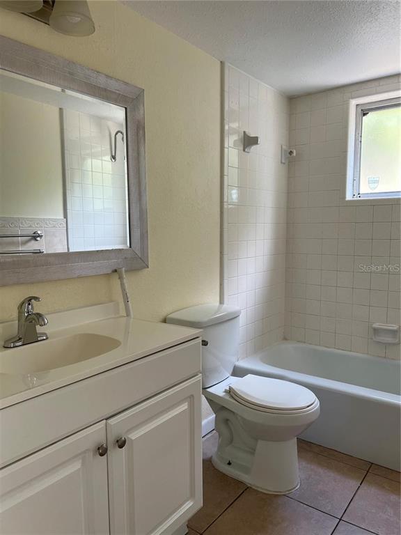 2176 Winchester Road North, Unit 2 St. Petersburg, FL 33710 - Photo 8 of 9 a bathroom with a sink a toilet and shower