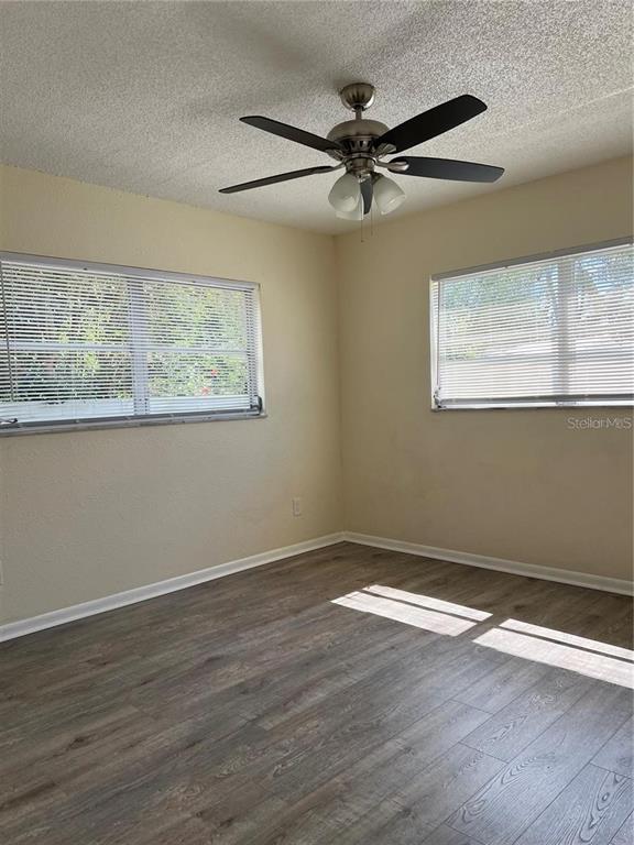 2176 Winchester Road North, Unit 2 St. Petersburg, FL 33710 - Photo 9 of 9 a view of a big room with wooden floor and windows