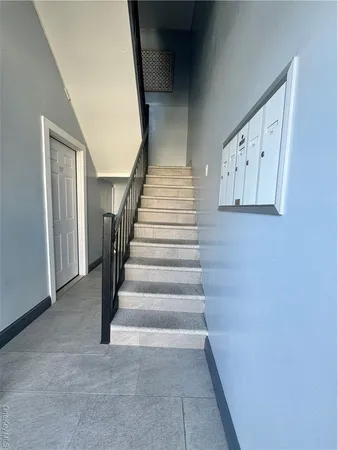 a view of staircase with white walls