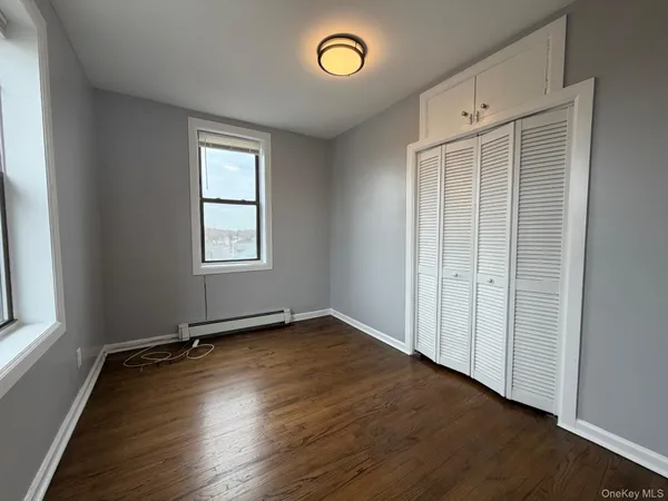 an empty room with windows and wooden door