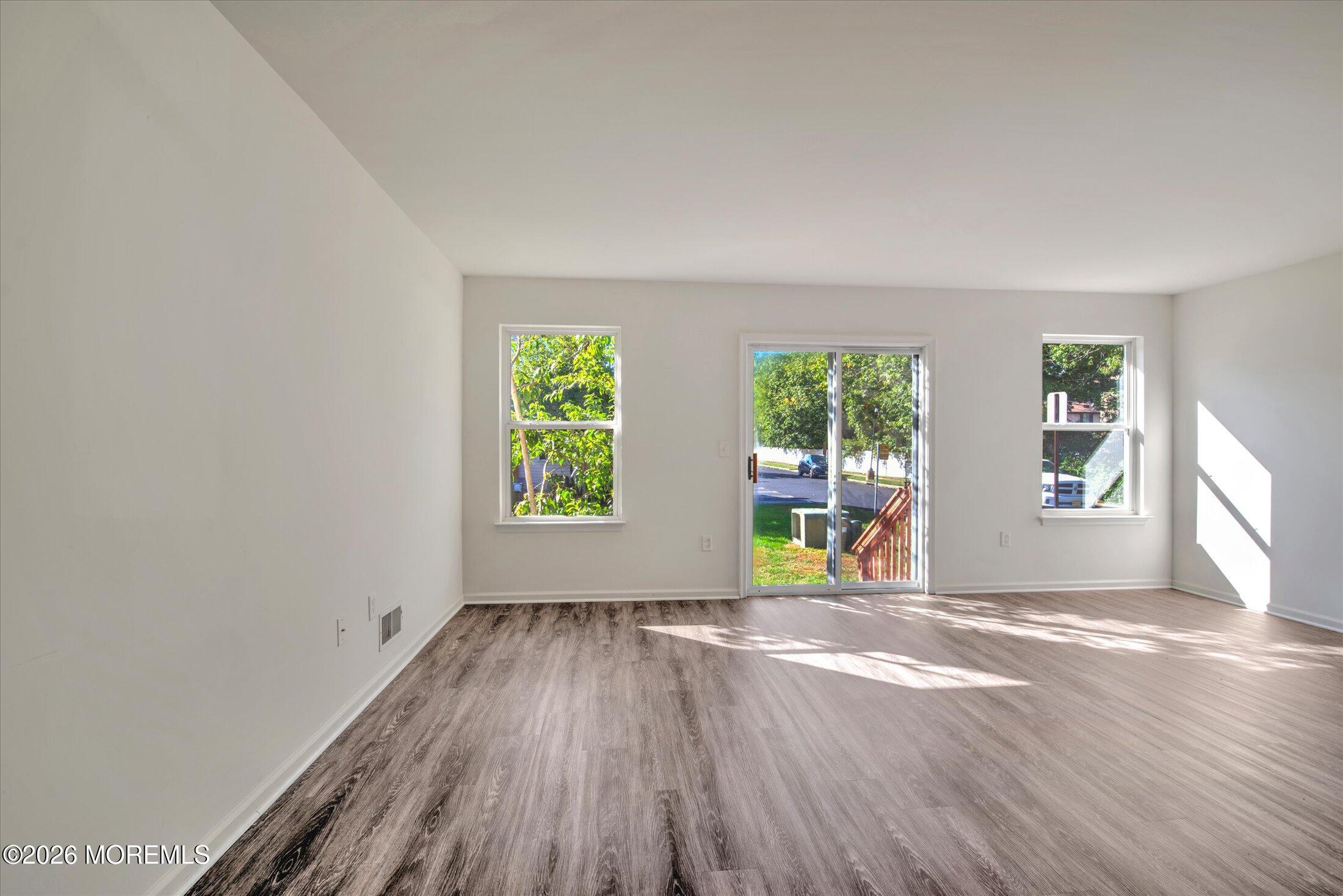 6 Esplanade Way Bayville, NJ 08721 - Photo 11 of 41 an empty room with windows and wooden floor