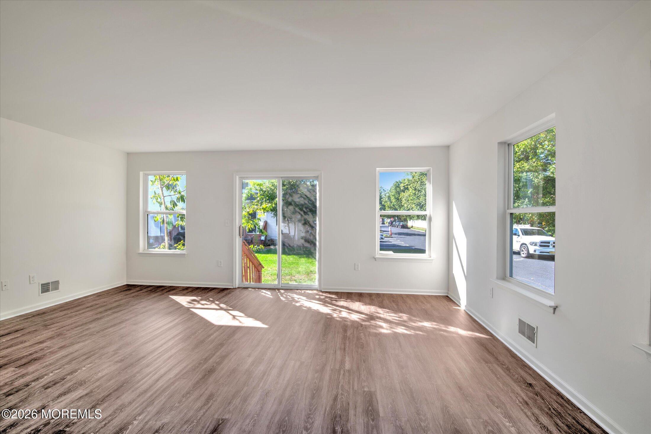 6 Esplanade Way Bayville, NJ 08721 - Photo 4 of 41 a view of an empty room with wooden floor and a window