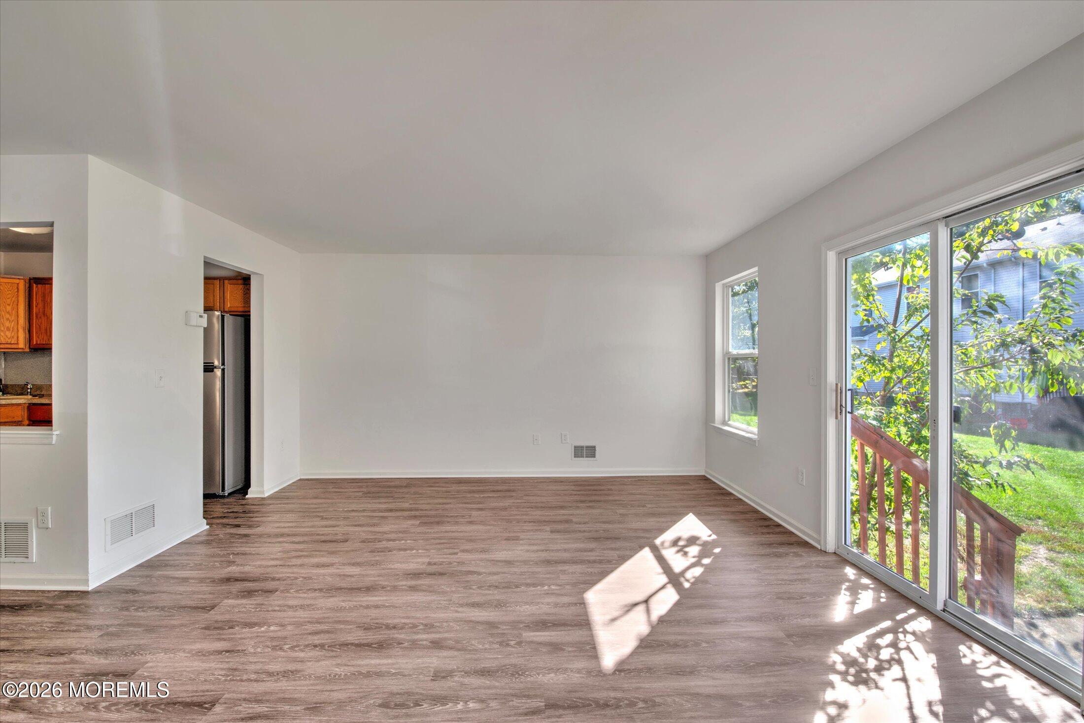 6 Esplanade Way Bayville, NJ 08721 - Photo 5 of 41 a view of empty room with wooden floor and fan