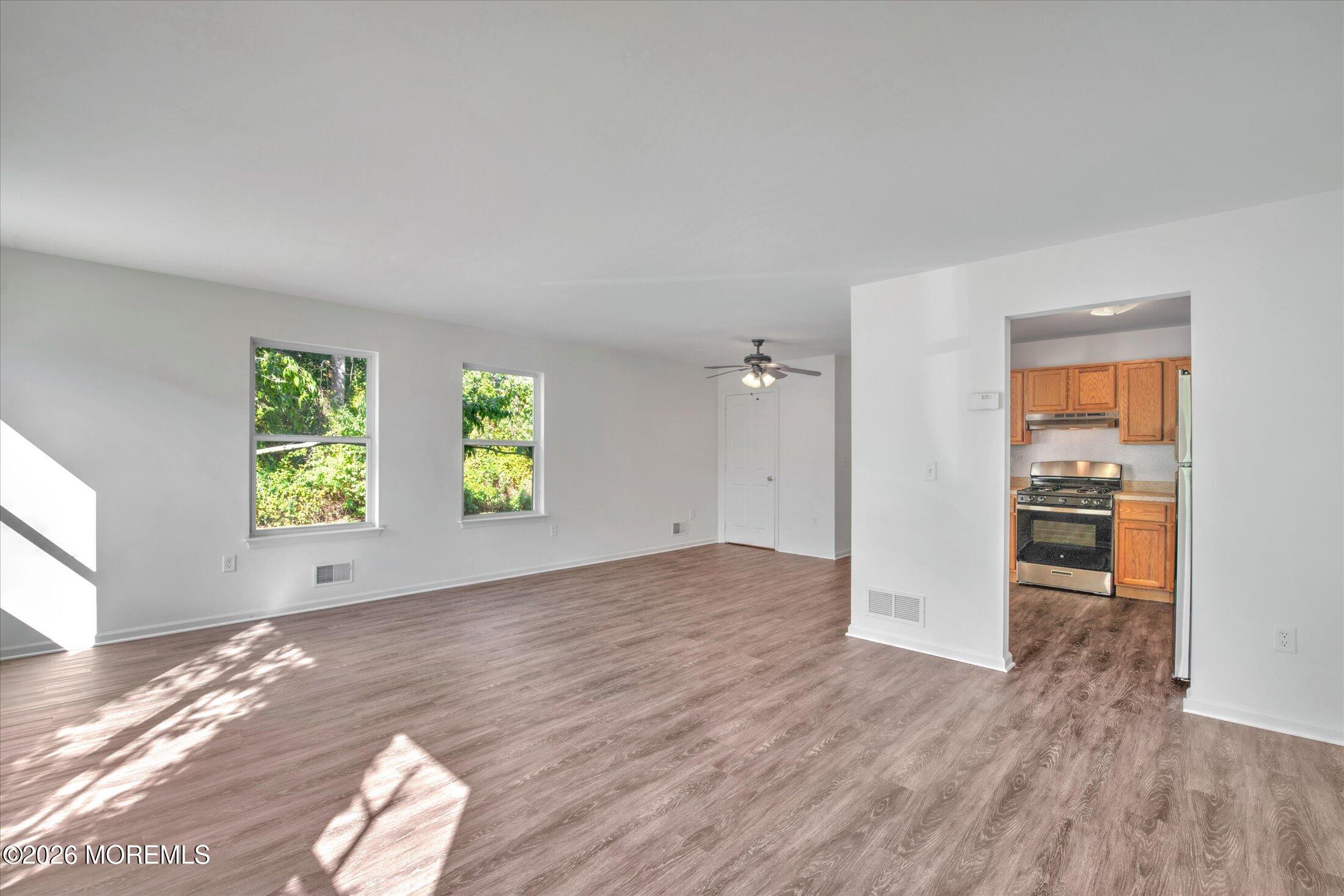 6 Esplanade Way Bayville, NJ 08721 - Photo 8 of 41 wooden floor in an empty room with a window