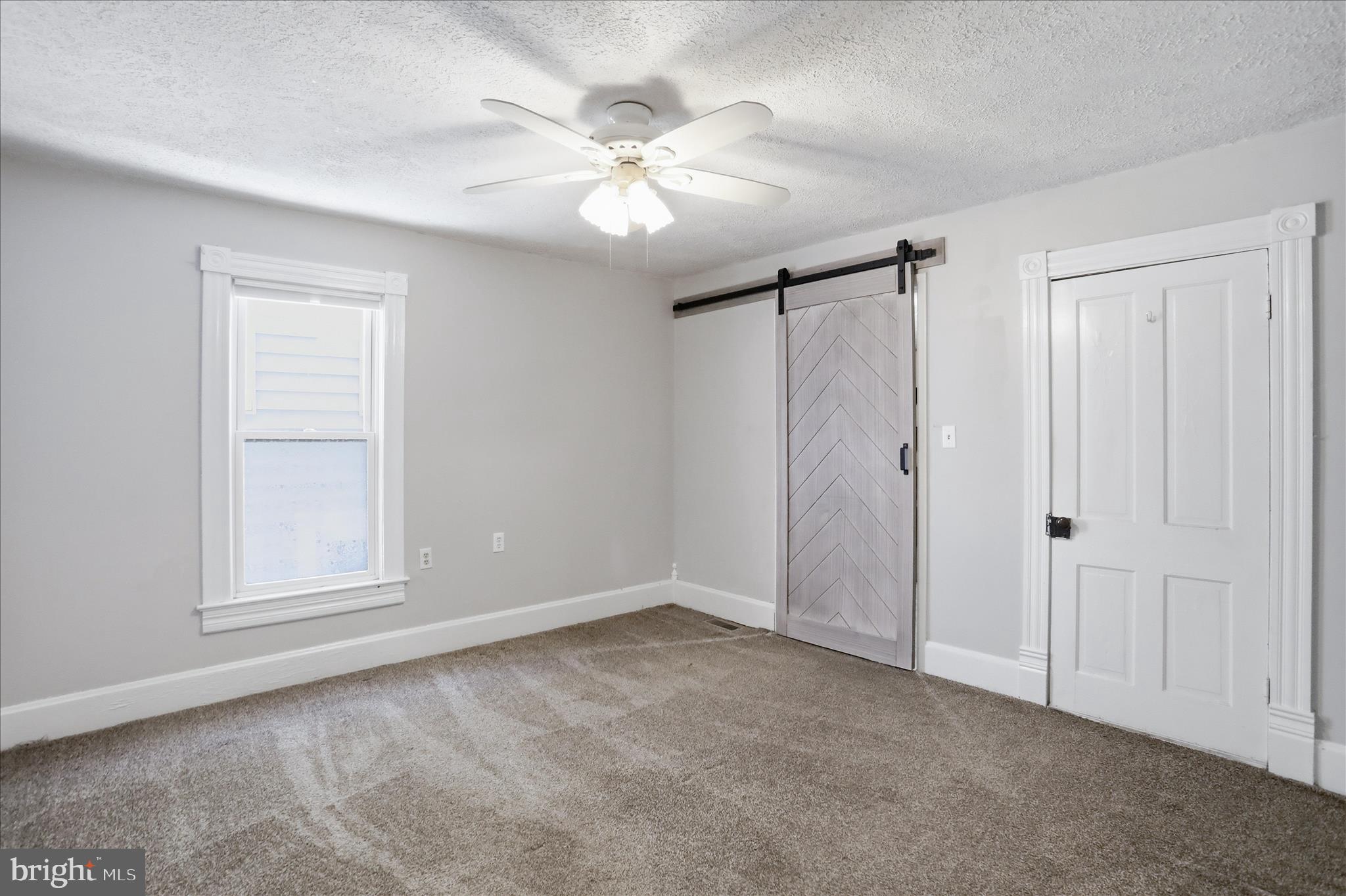 21 Sharpless Street Keyser, WV 26726 - Photo 19 of 33 an empty room with chandelier fan and windows