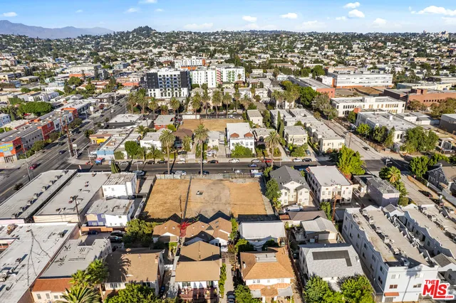 an aerial view of residential houses with city view