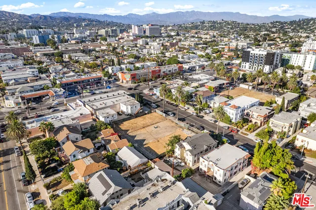 an aerial view of residential houses with city view