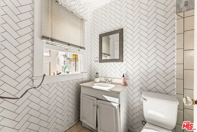 a kitchen with a refrigerator and a sink