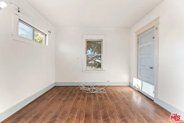 a bathroom with a toilet a sink a window and mirror
