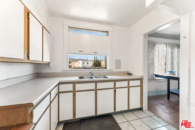 a view of a room with wooden floor and windows