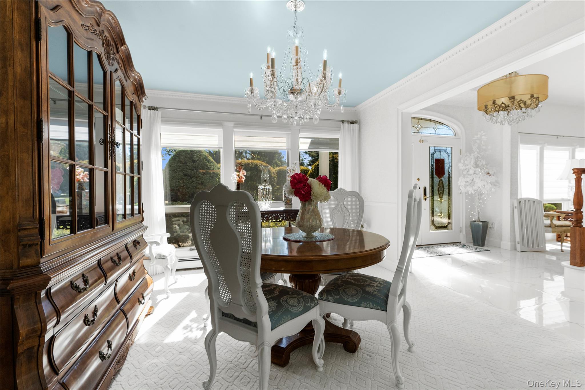 28 Annandale Road Commack, NY 11725 - Photo 11 of 29 a view of a dining room with furniture a chandelier and large windows