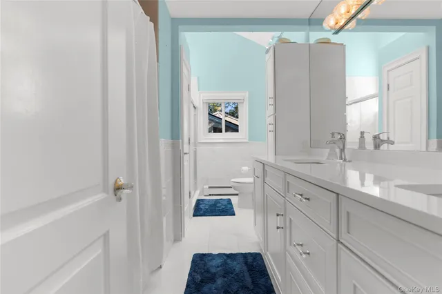 a white toilet sitting next to a bathroom sink