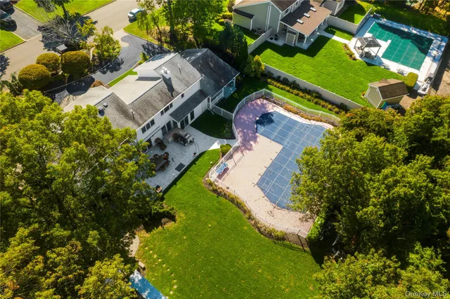 a front view of a house with a yard and lake view