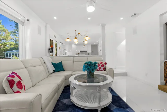 a bathroom with a granite countertop toilet sink and mirror
