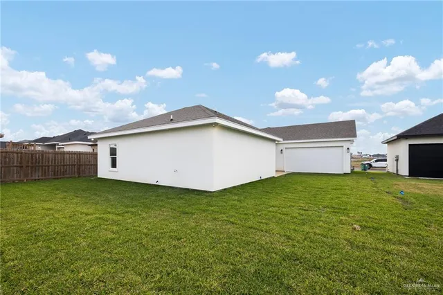 a view of an house with backyard space and balcony