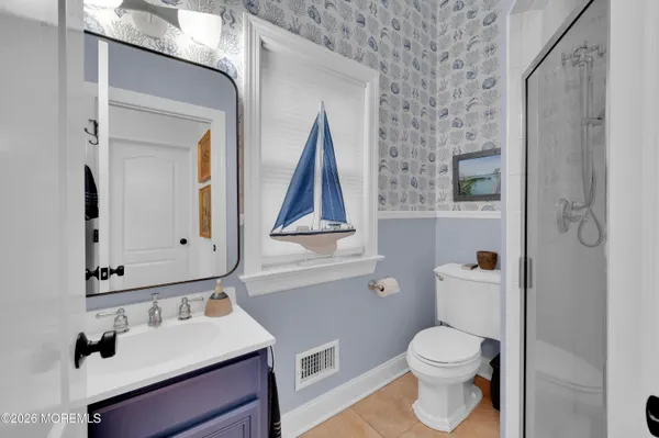 a large kitchen with stainless steel appliances kitchen island a large counter top and a wooden floors