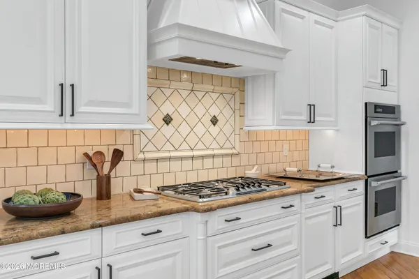 a view of a dining room with furniture large windows and wooden floor