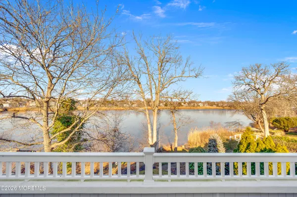 a bathroom with a granite countertop sink mirror vanity and toilet