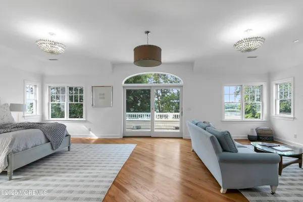 a living room with furniture a flat screen tv and kitchen view