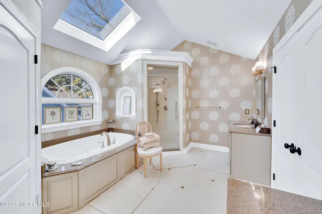 a living room with furniture a flat screen tv and kitchen view