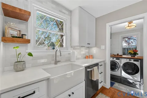 a kitchen with a sink a stove and cabinets