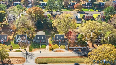 a view of a swimming pool with lawn chairs and potted plants