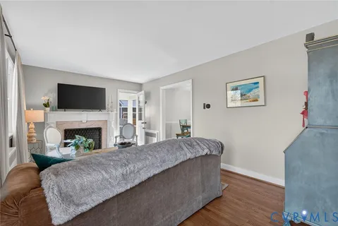 a living room with furniture a fireplace and a flat screen tv