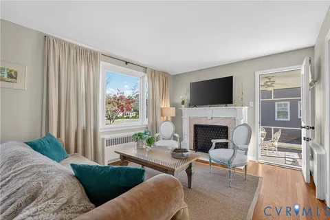a living room with furniture fireplace and flat screen tv