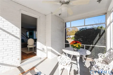 a dining room with furniture and a floor to ceiling window