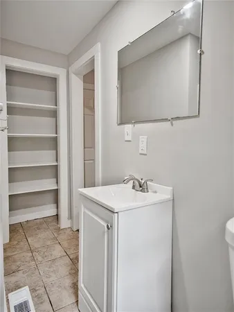 a view of a small space with wooden floor and a ceiling fan