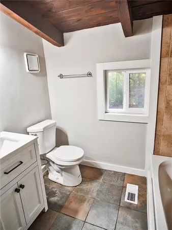 a view of a room with wooden floor and windows