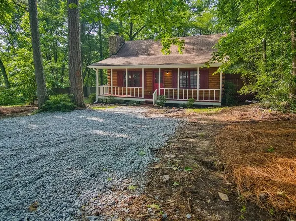 a view of a house with backyard and a tree