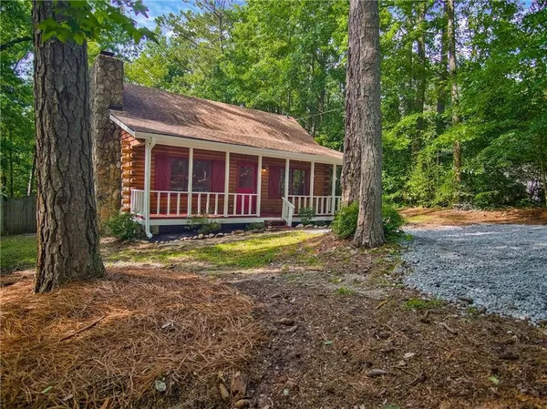 a view of a house with a yard and plants
