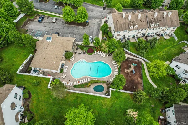 an aerial view of a house with garden space pool seating area and yard