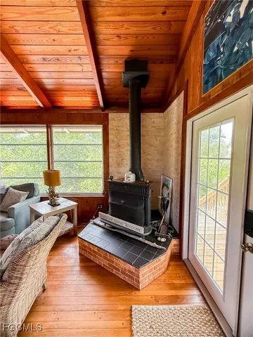 a living room with patio furniture and a floor to ceiling window