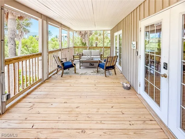 a view of a room with wooden floor and furniture