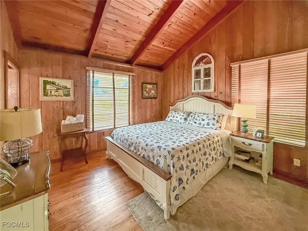 a bedroom with a bed next to a window with outer view