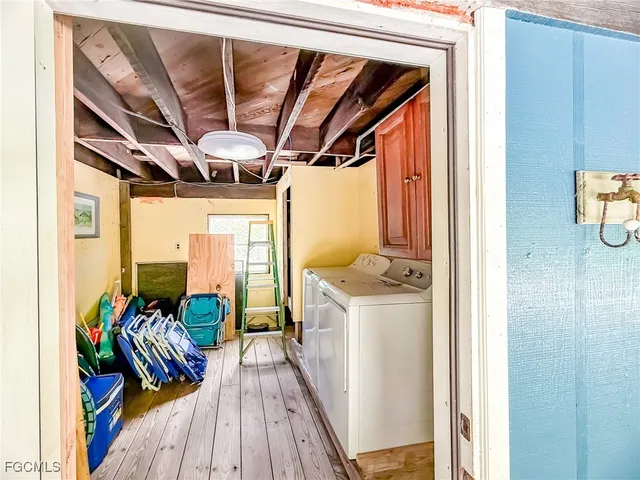 a view of a hallway with wooden floor and furniture