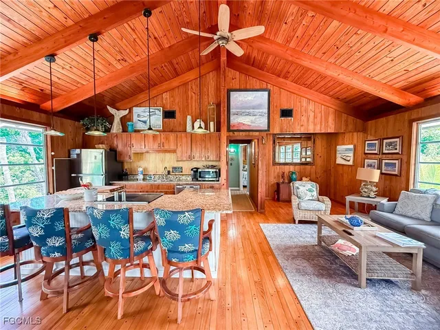 a view of a patio with dining table and chairs under an umbrella